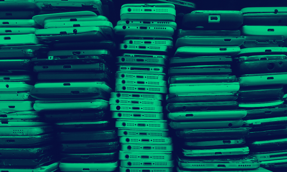 Photo of a stack of mobile smartphones. 